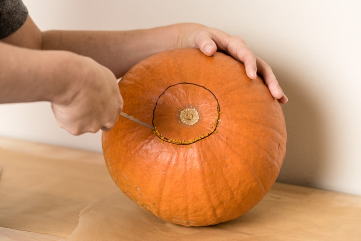 How to carve a pumpkin steps: carve out the bottom - Dr. Axe