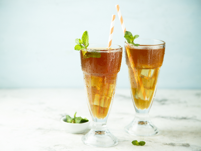 Homemade iced tea with mint and lemon or Arnold Palmer drink