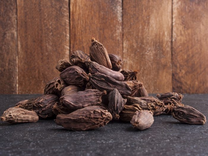 Black cardamoms on a dark counter