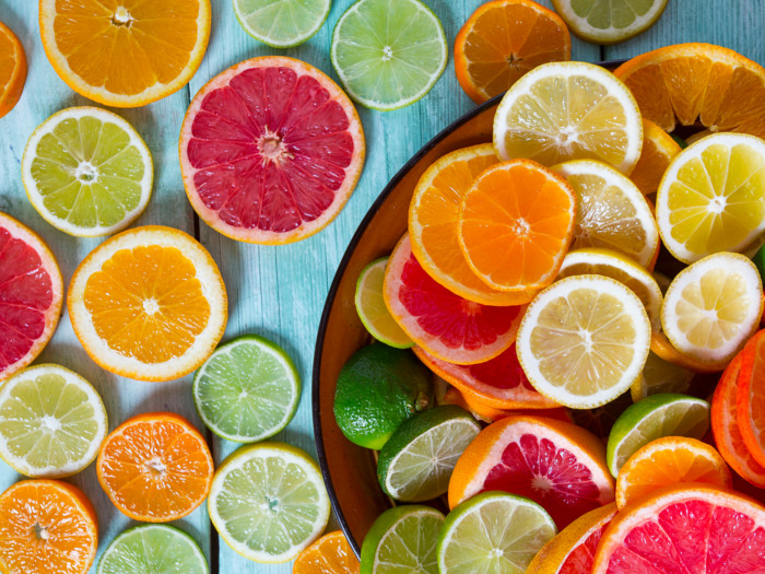 A variety of sliced citrus fruits on a surface