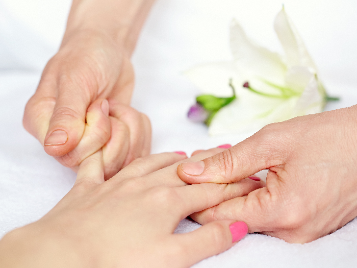 Close-up shot of a hand being massaged by another pair of hands