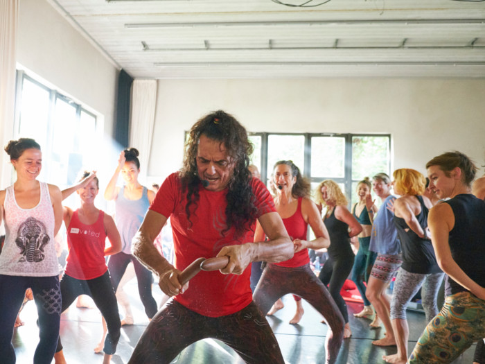 Yoga expert, Jose, teaching a class full of students yoga