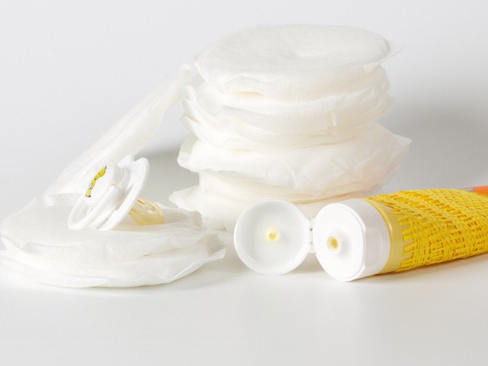 Tube of cream with a mound of cream placed next to it.