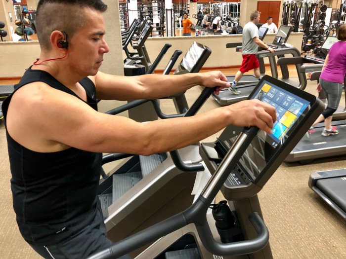 A man exercising in the gym using a Stairmaster