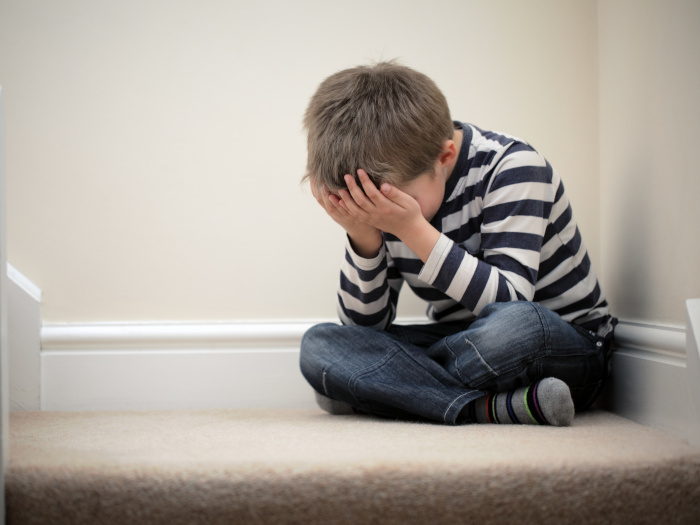 Child feeling upset due to bullying and depression