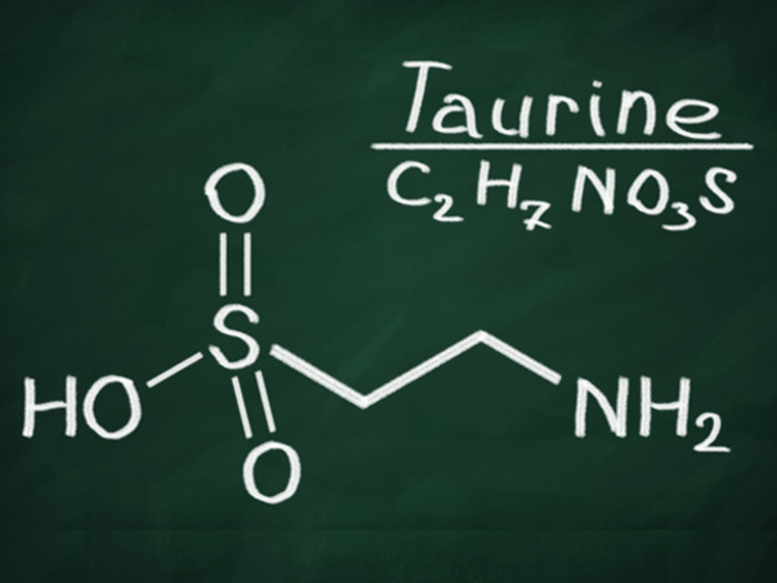 Chemical structure and formula of taurine on a green background.
