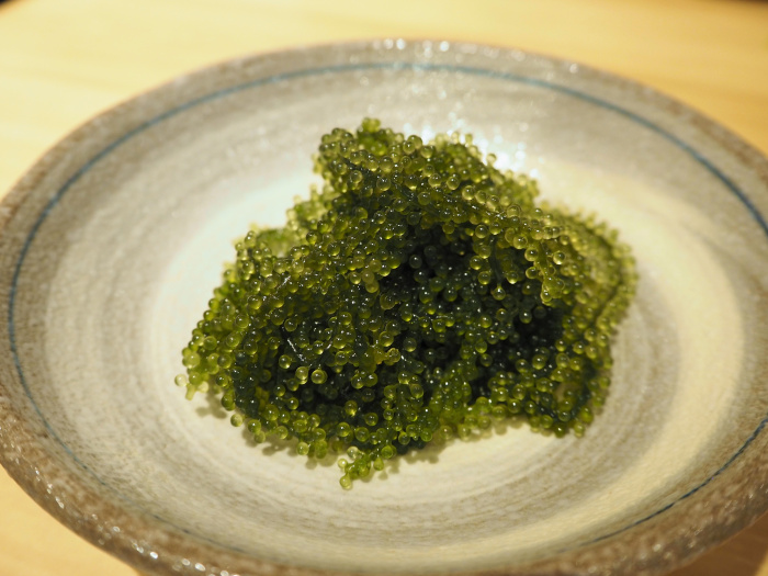 Fresh sea grapes (Umibudo/seaweed) in a white plate